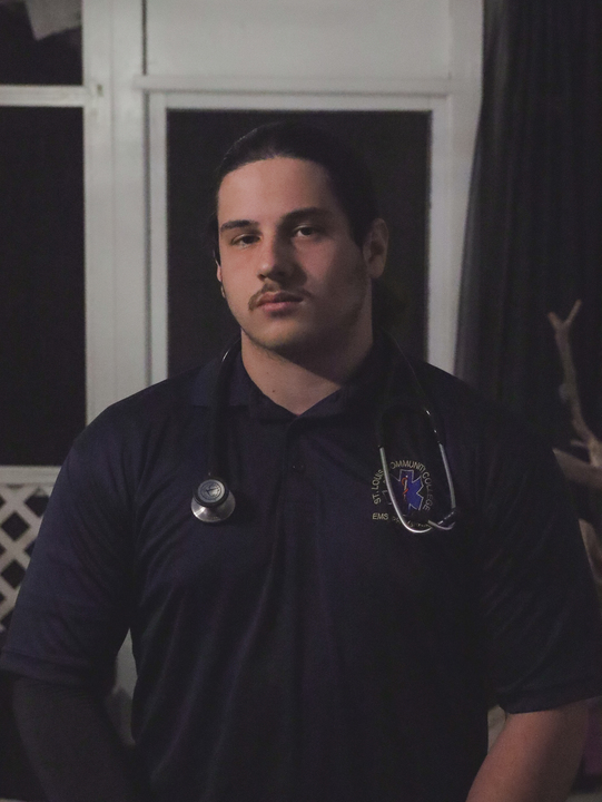 Timmy Talir, senior, standing in his EMT uniform.