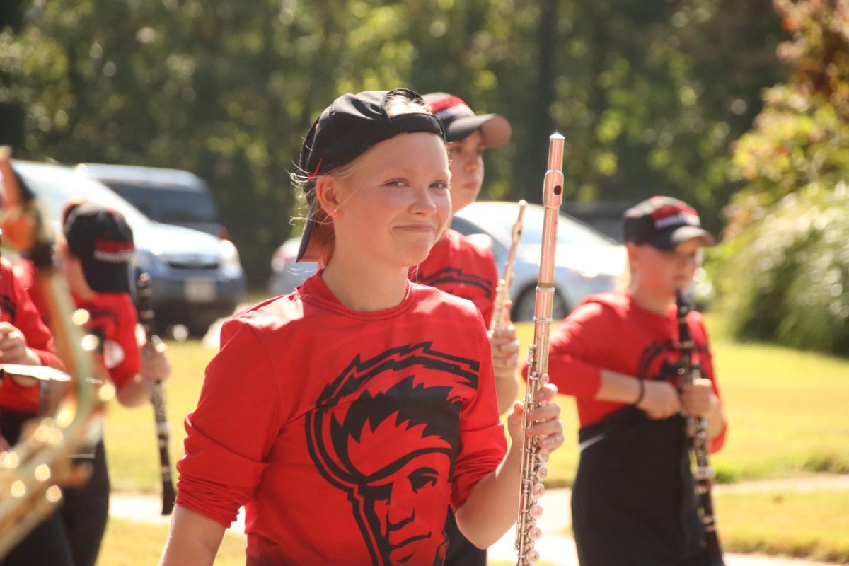 Jenna Braun, junior, marches in the parade with her flute.