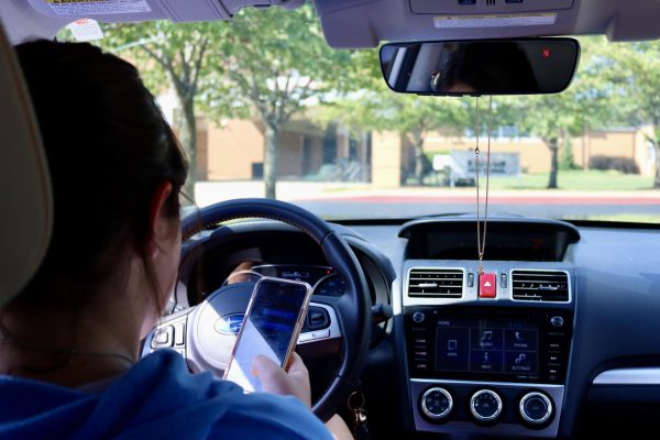 A KHS student drives while distracted in the Essex parking lot