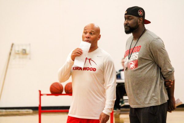 Coaches Jonnie Parker and Nelson Taylor show signs of interest in competing players during basketball tryouts.