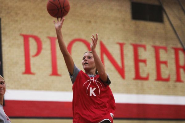 Clare Phillip shooting a basketball in girls basketball tryouts. 