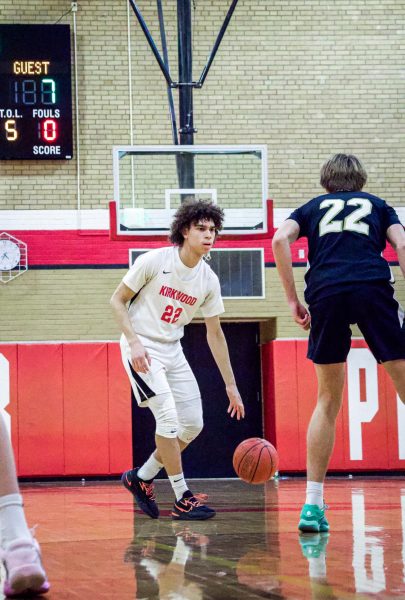 Sebastian Powell, freshman, looking at the court after being swung the ball to the top of the key. He decided to drive into the paint and pass it out.